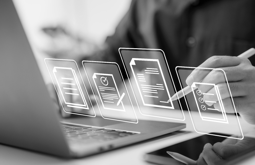 A man focused on his laptop, creating a document against a clean white background